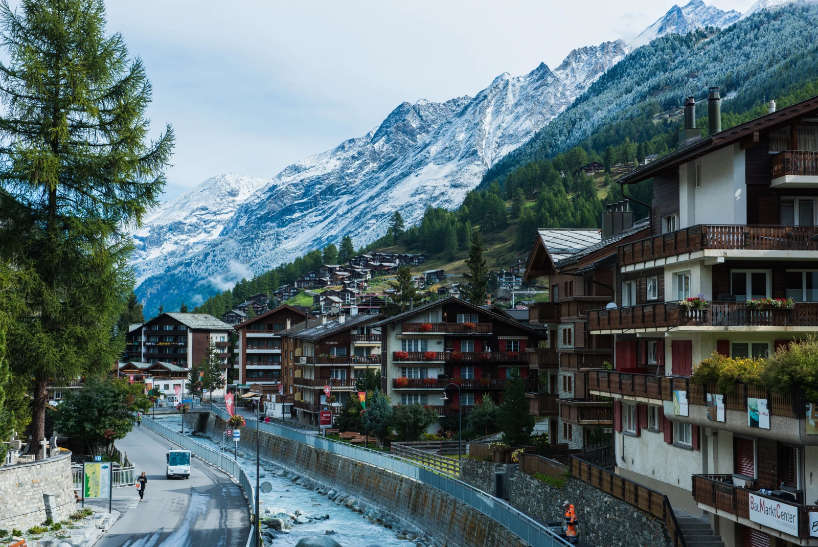 A view of Zermatt with a river and wooden chalets. 