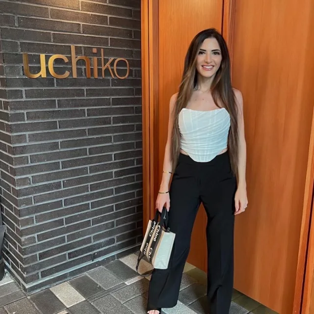 Travel Advisor Lauren Ruehl in a light tank top and a black palazzo pants.  
