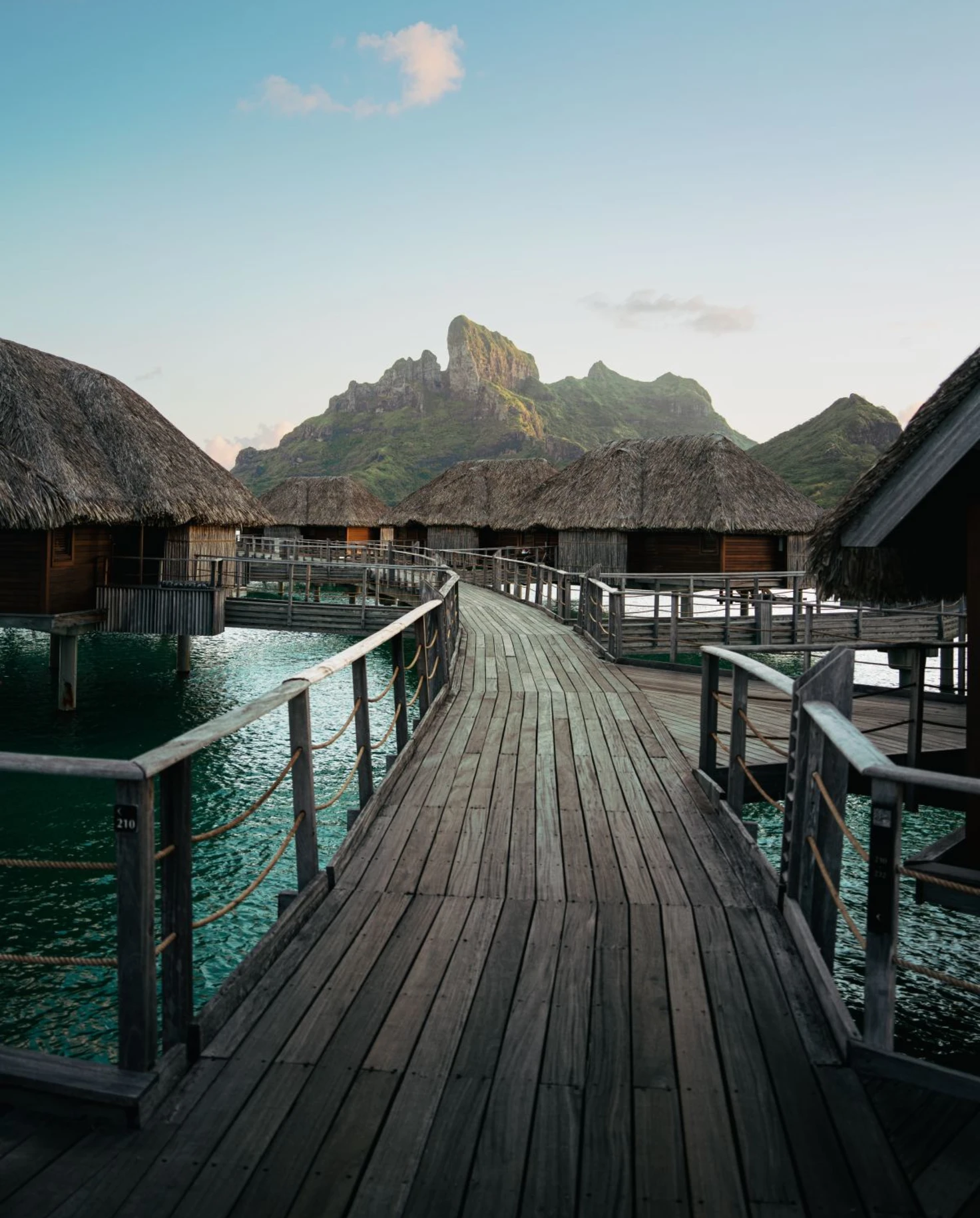 wooden pathway leading to numerous over-water bungalows