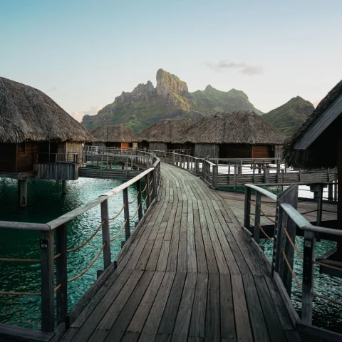 wooden pathway leading to numerous over-water bungalows