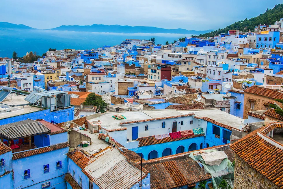 Bright blue view of Morocco with mountains in the distance.