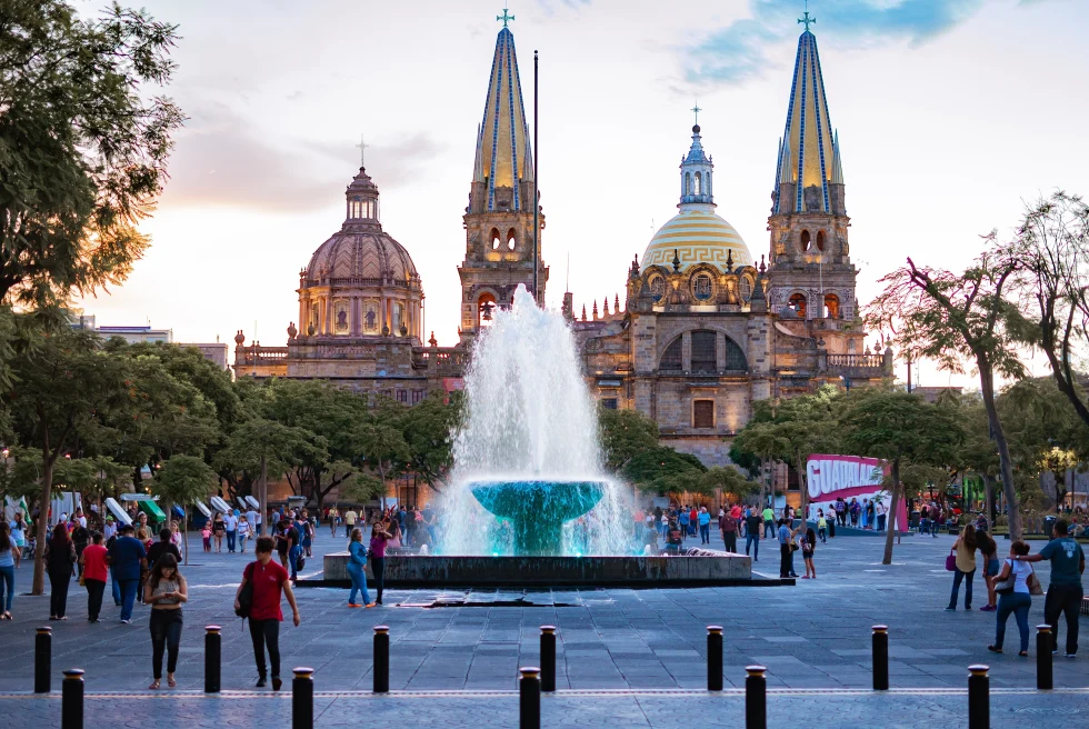 A fountain in front of a huge historic building.