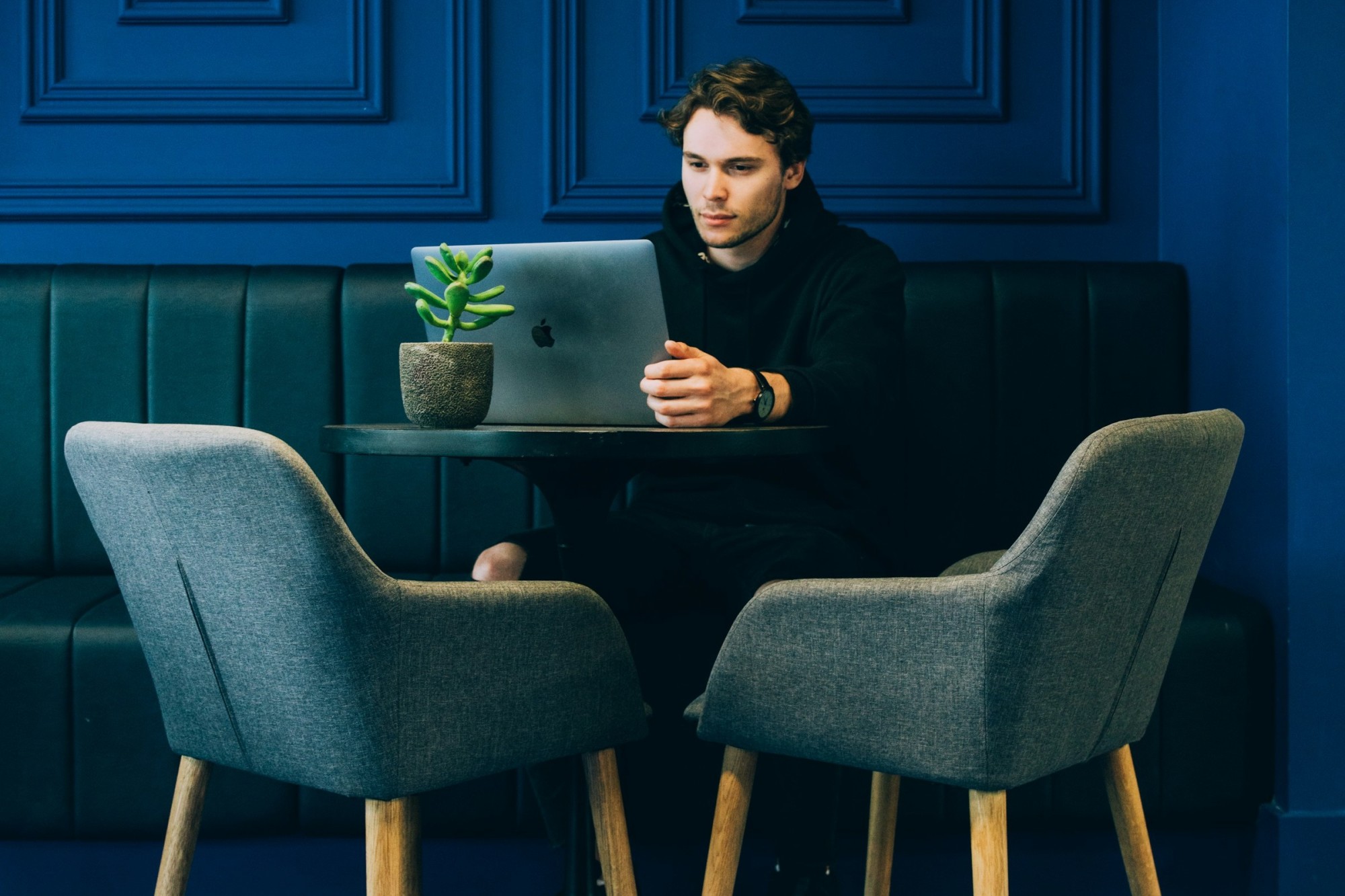 A man works on his laptop in a bold and vibrant contemporary-design setting