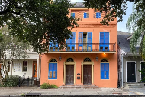 orange New Orleans home with blue shutters