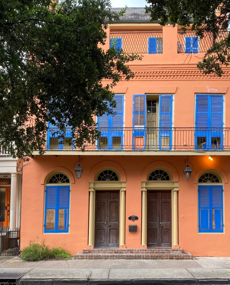 orange New Orleans home with blue shutters