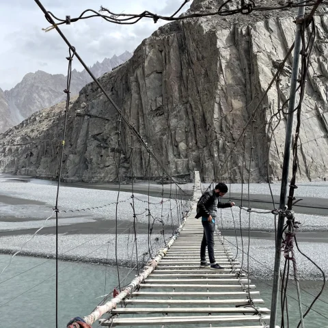 A guy on a rope bridge in Pakistan.