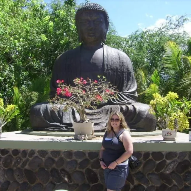 Travel Advisor Jennifer Wike in front of a Buddha statue.