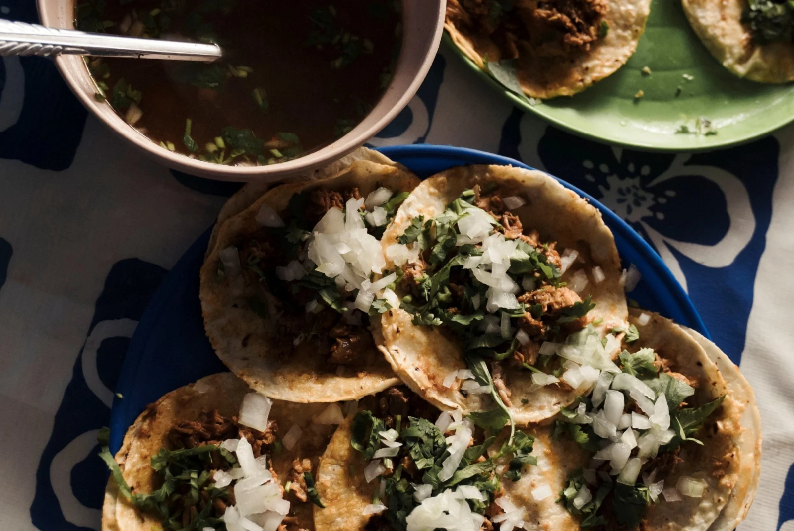 aerial view of small tacos with black beans, onions, and cilantro