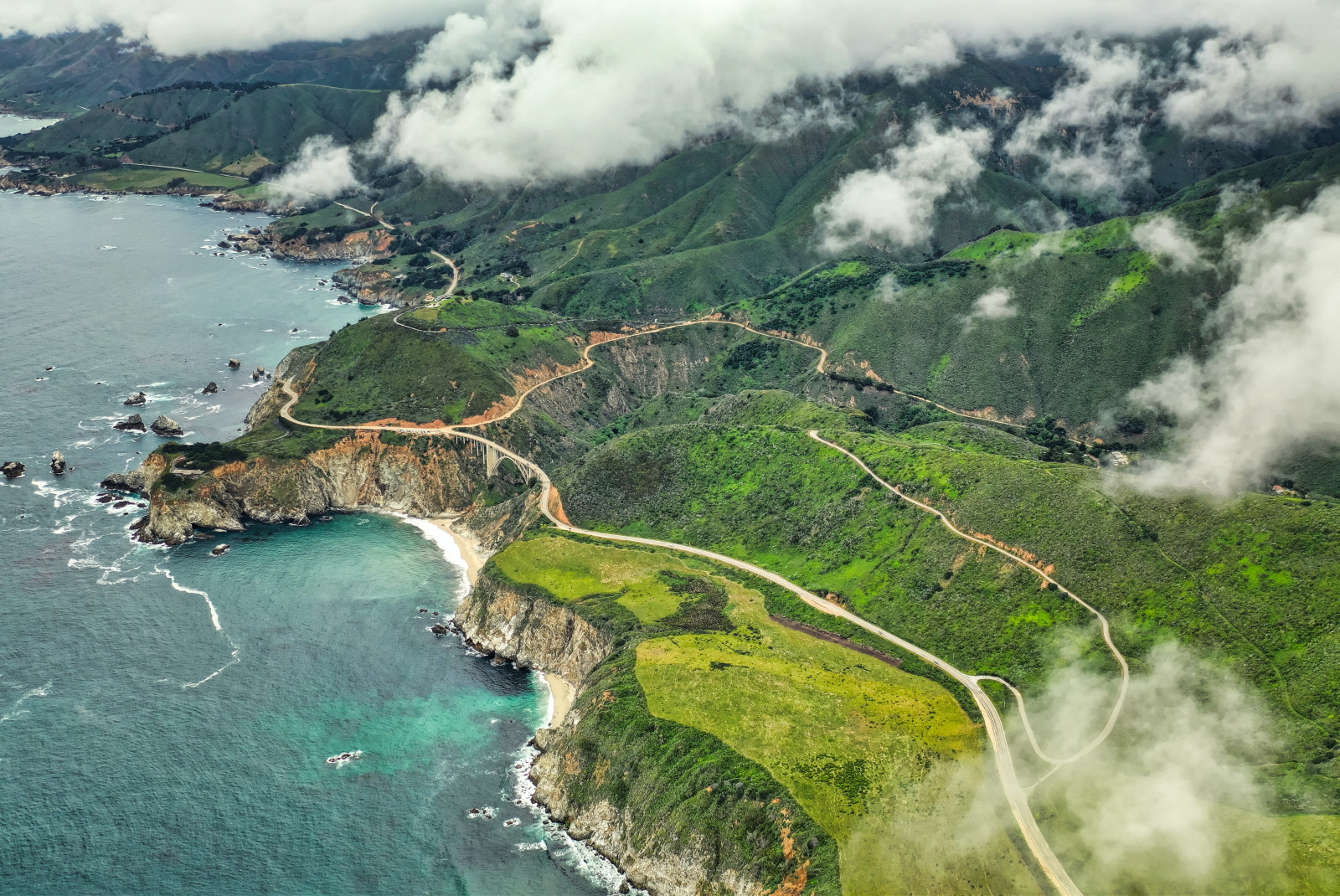 aerial view of coastline with cloudy skies