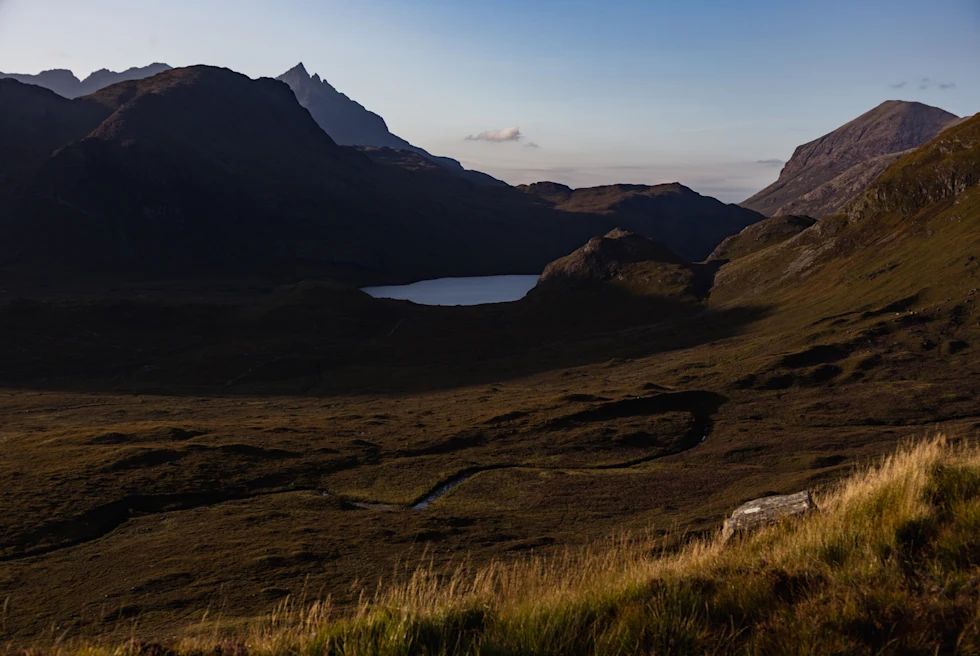 small body of water next to mountains