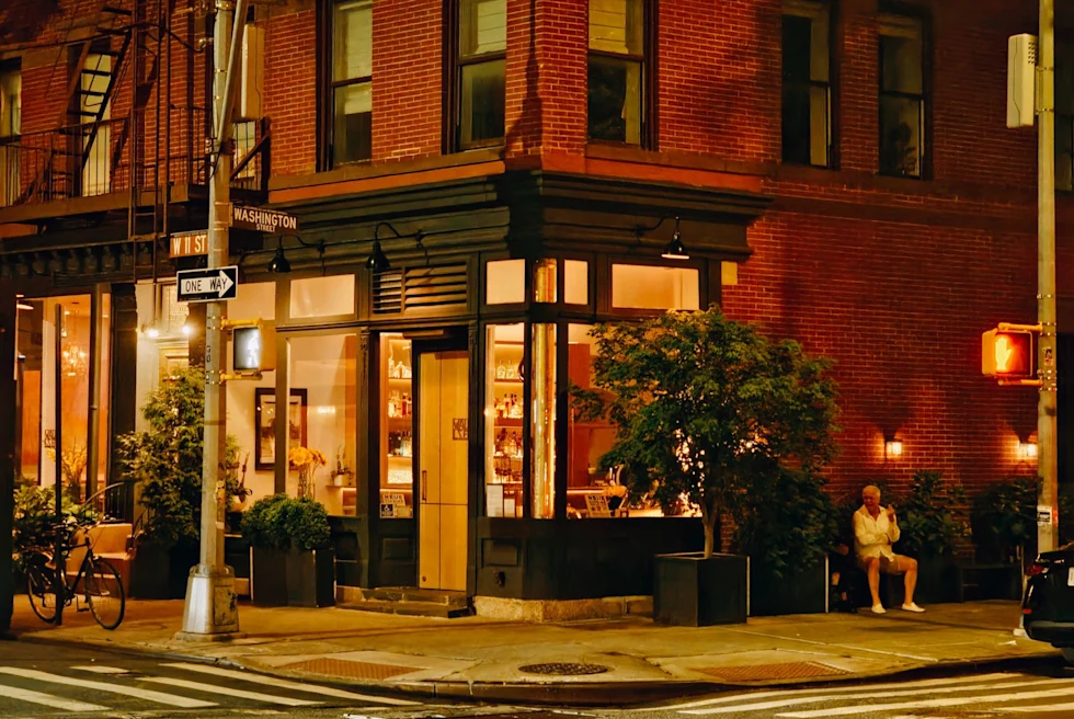 small city street lit by lamp and window light