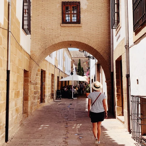 woman walking down alleyway