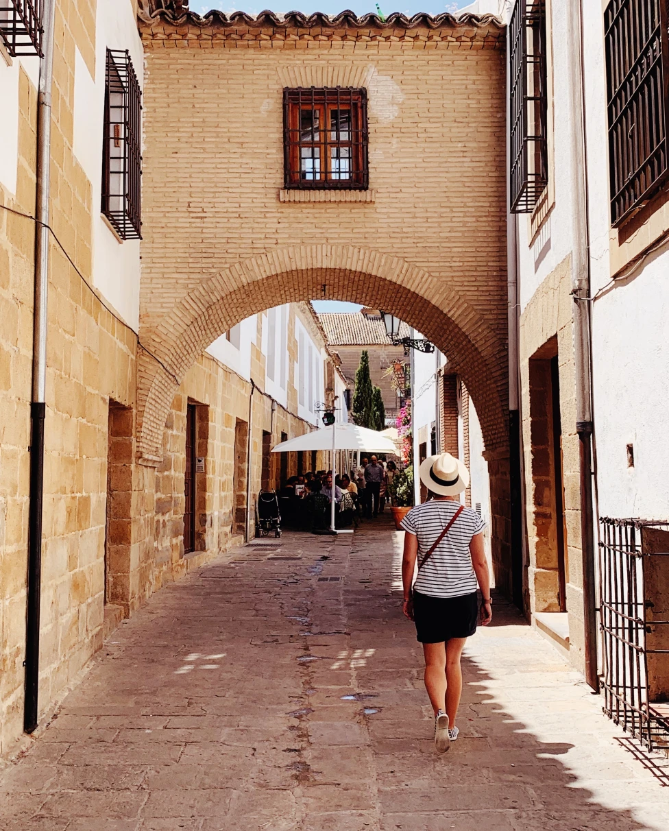 woman walking down alleyway