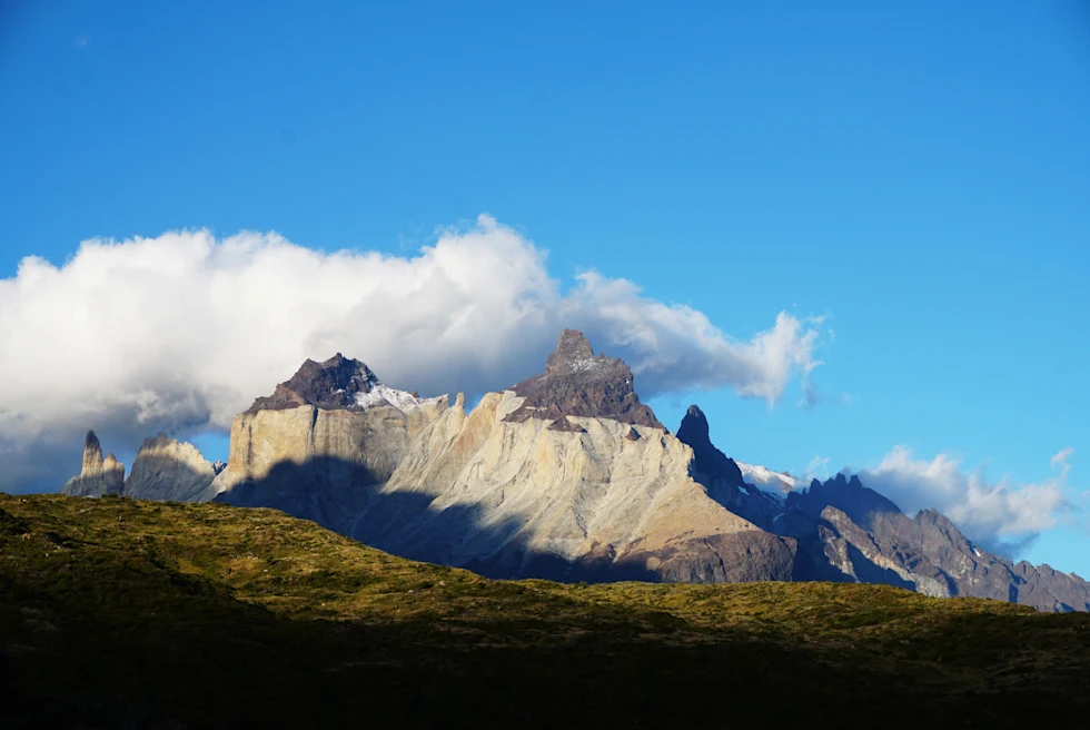 shadows on mountain under blue sky