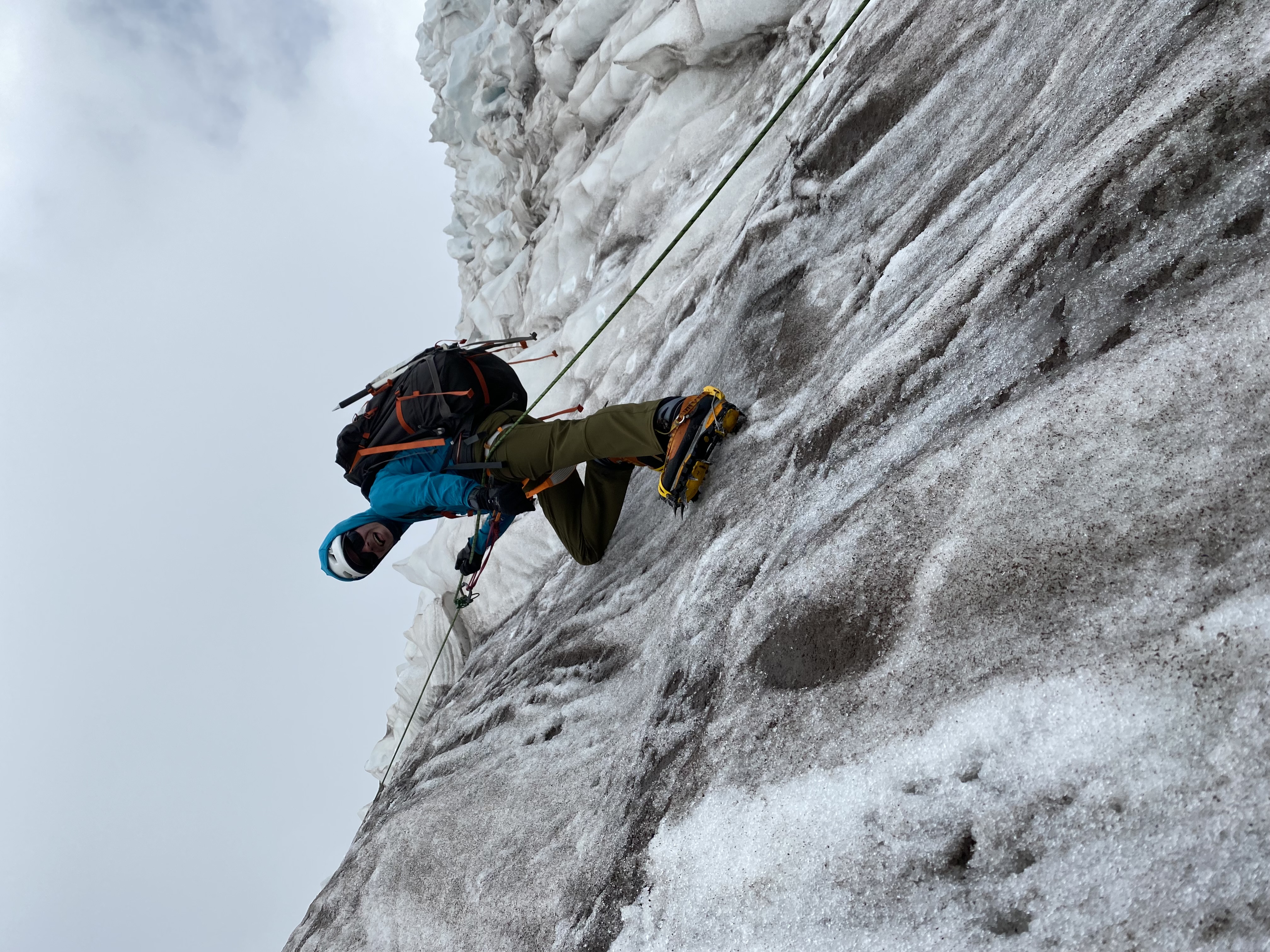 Stephen climbing at the top of rocky terrain outdoors