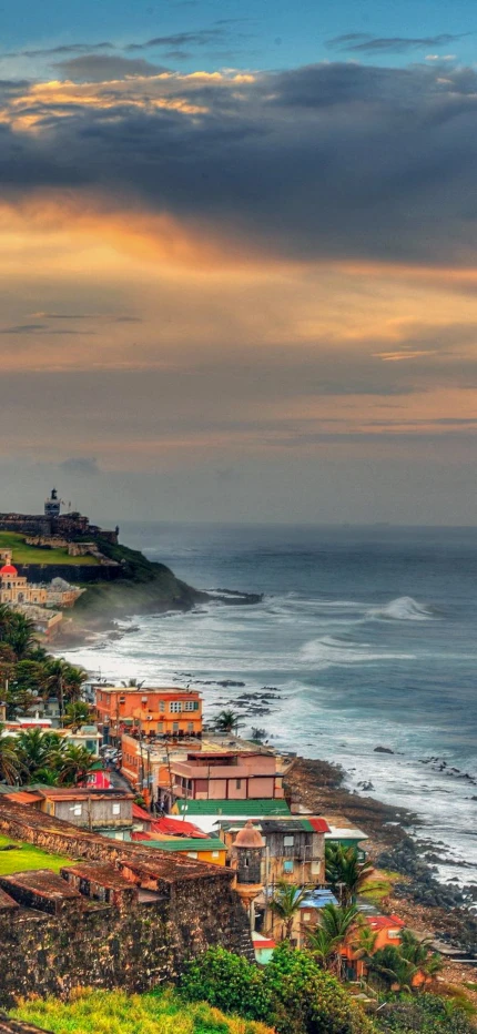 colorful buildings on coastline next to body of water during sunset