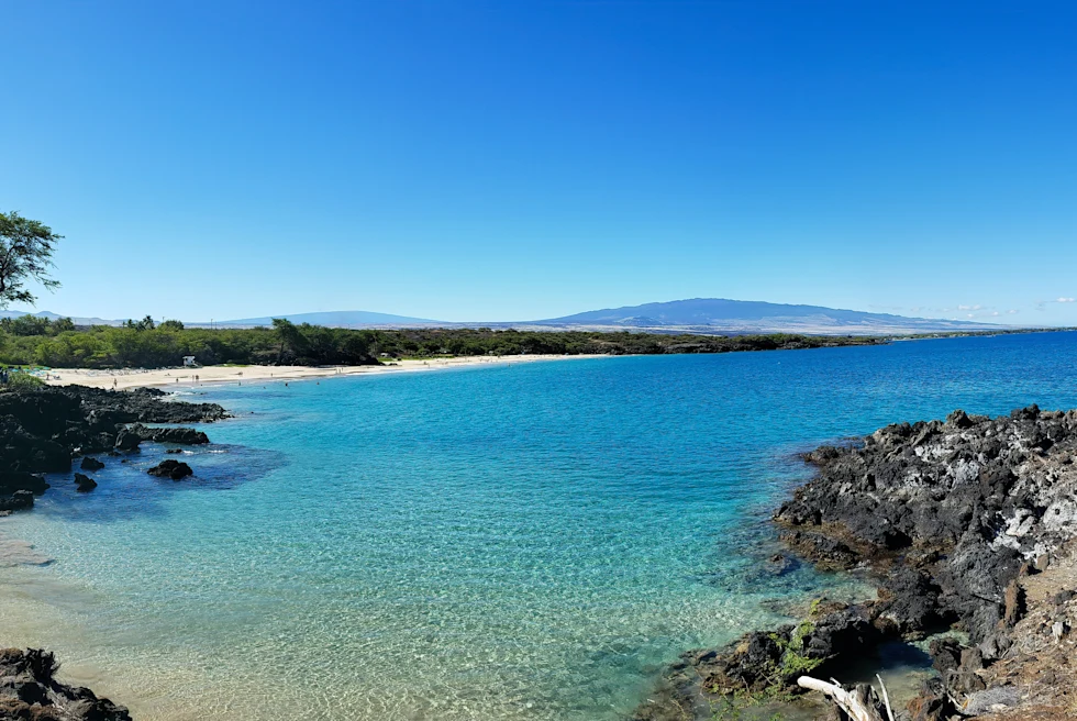 blue waters and white beach during daytime