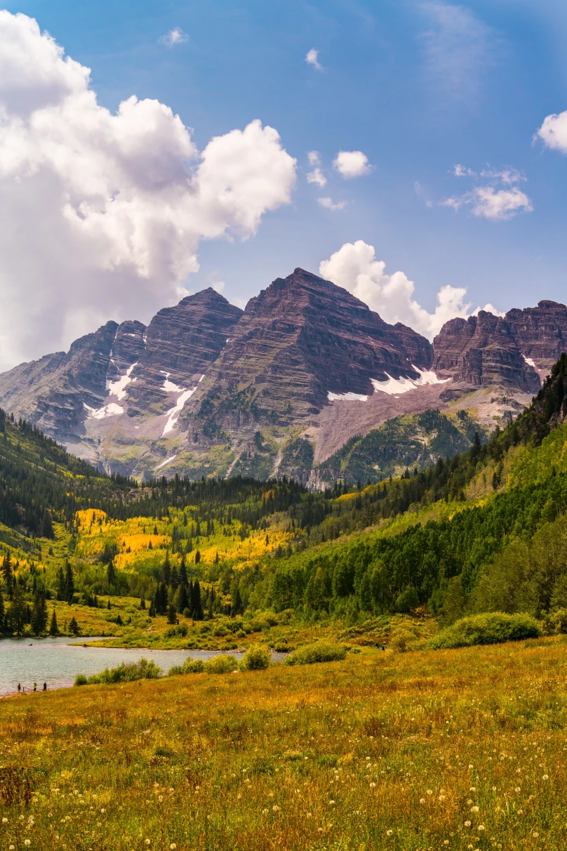Maroon Bells, the iconic twin peaks in the Colorado Rockies, renowned for their stunning reflection in Maroon Lake, attracting photographers and nature enthusiasts worldwide."