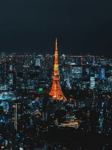 A lit-up skyline with Tokyo Tower in the center at nighttime.