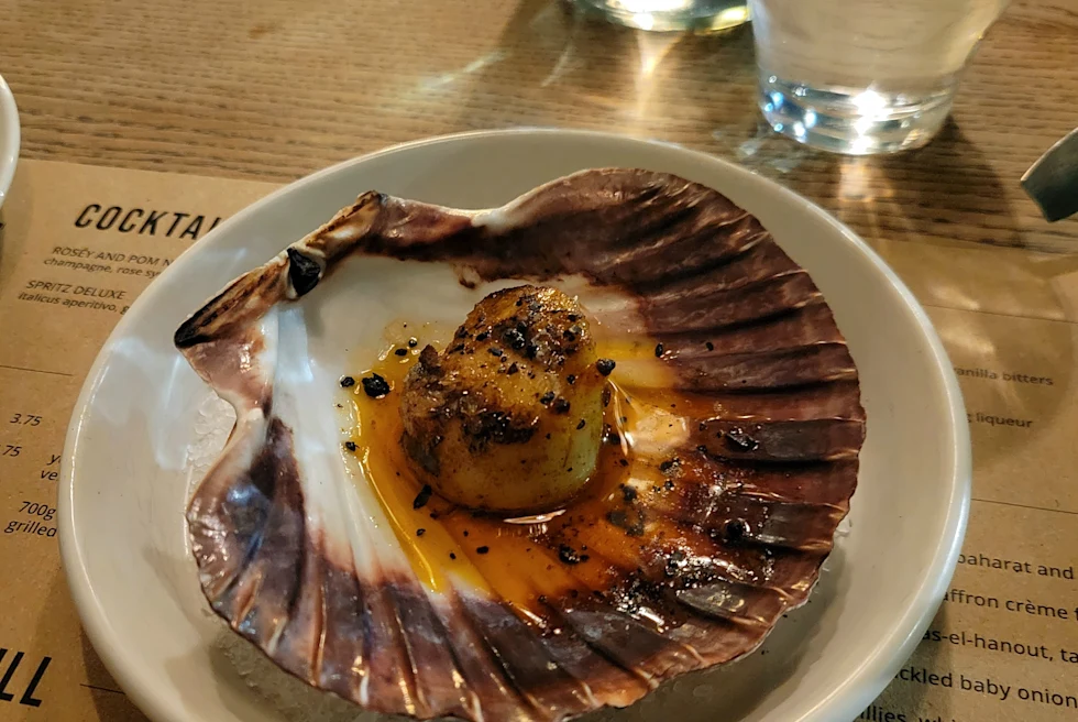An oyster served on a plate.