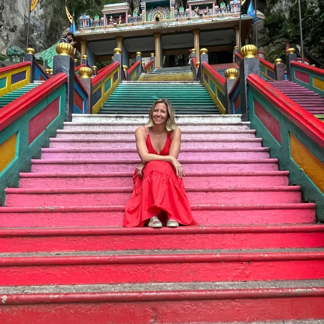 Travel Advisor Beth Grealy sitting on pink stairs.