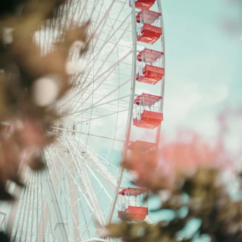 Pastel pink ferris wheel in Branson, Missouri on clear day.