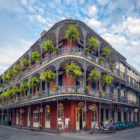 corner building with plants during daytime