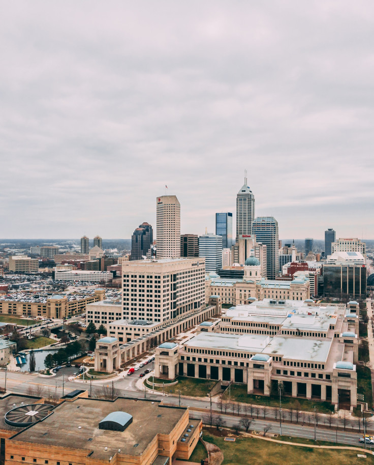 View of buildings and skyscrapers in downtown Indianapolis with a cloudy, grey sky