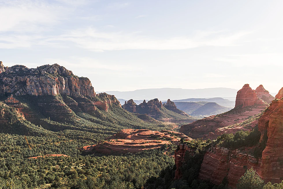 Sedona Arizona red clay mountains and green trees sun shining