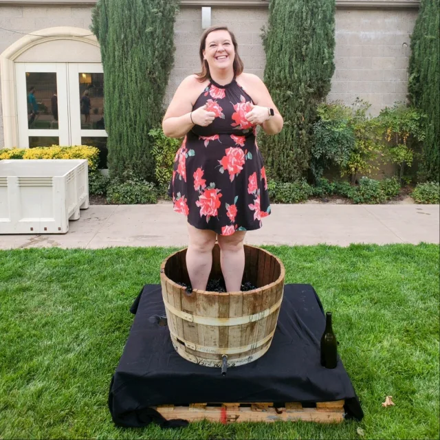 Picture of Molly in black floral dress standing in a bucket outside