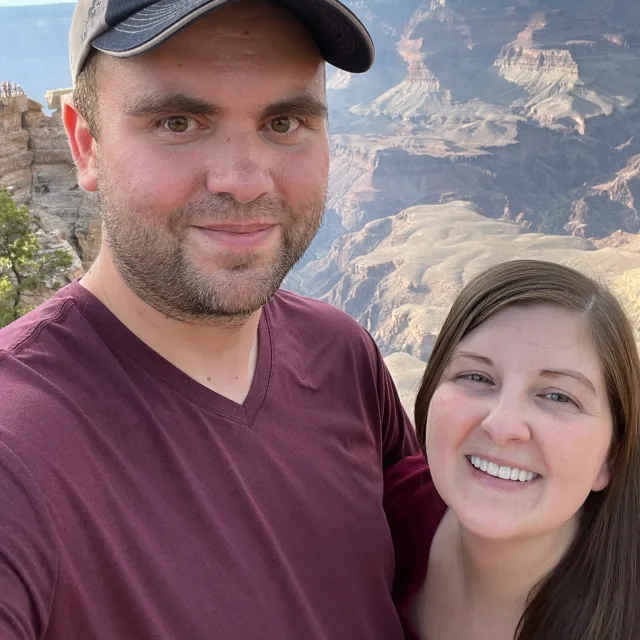 Travel advisor Kristi Martin poses with her husband at the top of a desert canyon