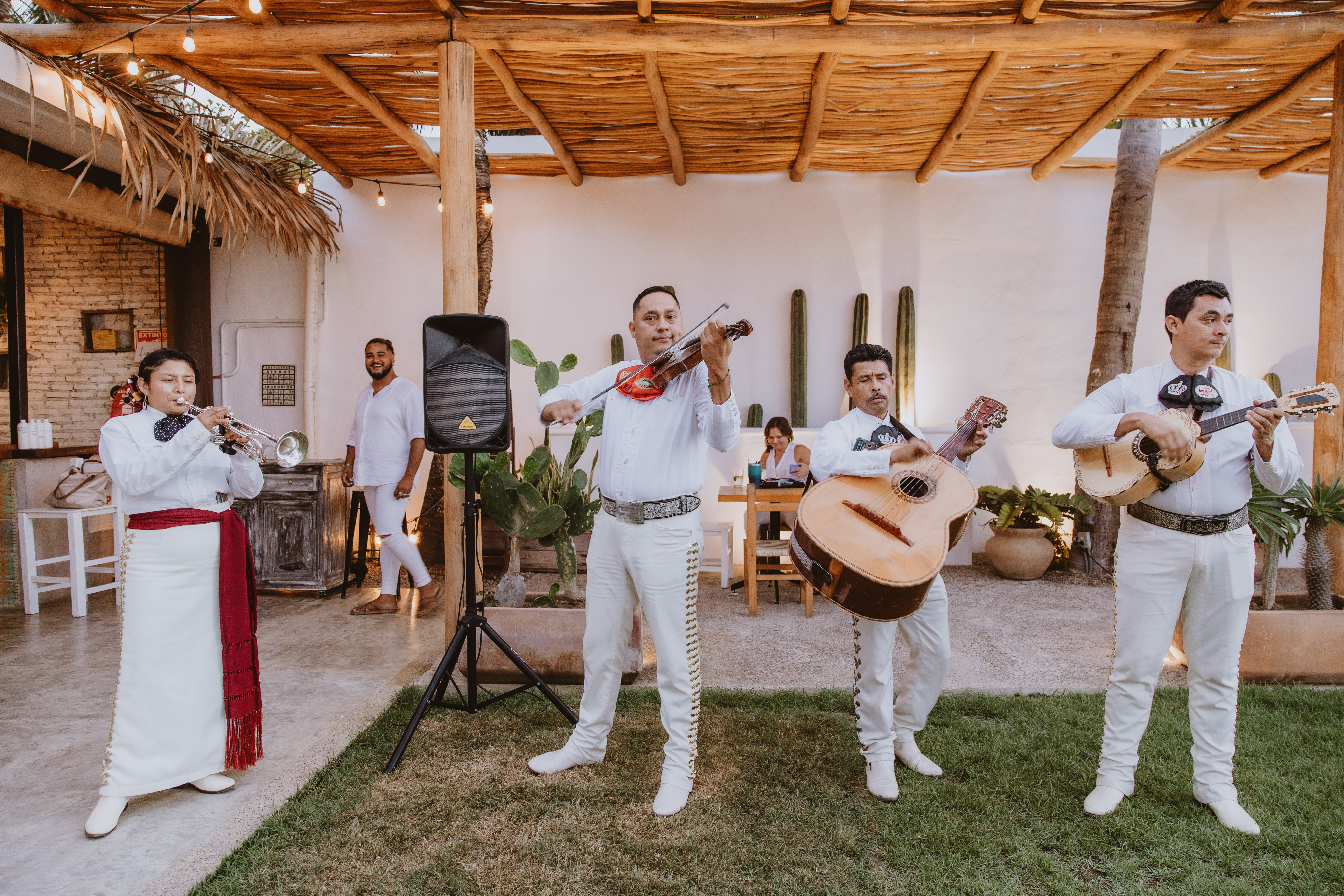 Men in white singing songs