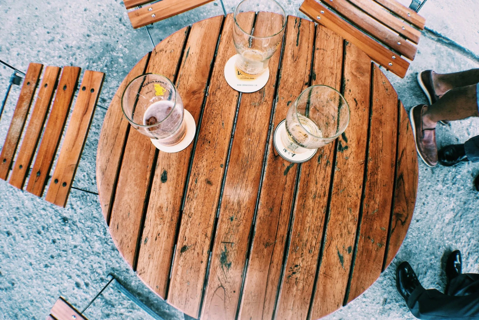 three different beers on a wooden table
