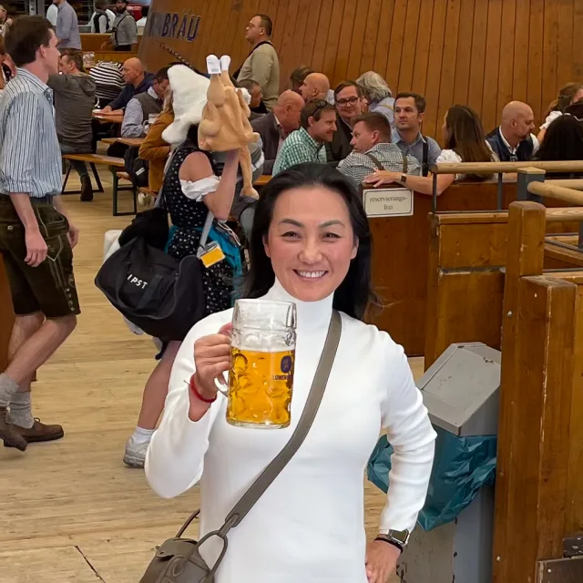 Travel advisor Jenny Hong smiling with a beer stein.