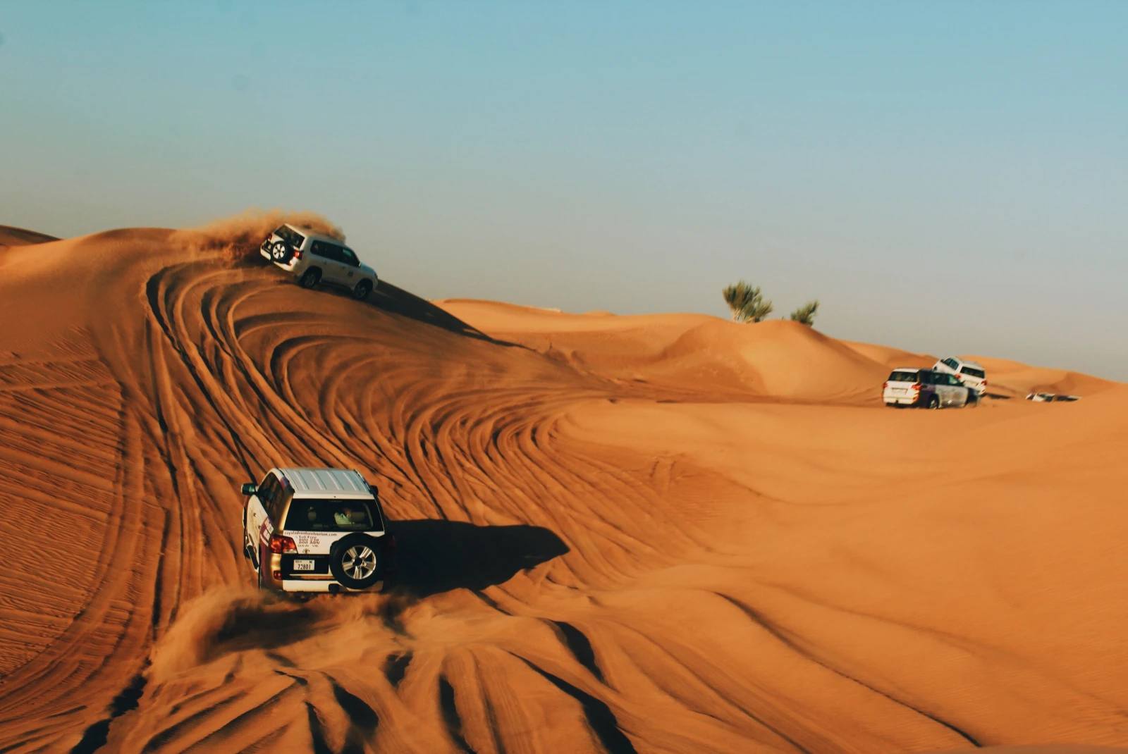 Cars driving on the golden desert in Dubai