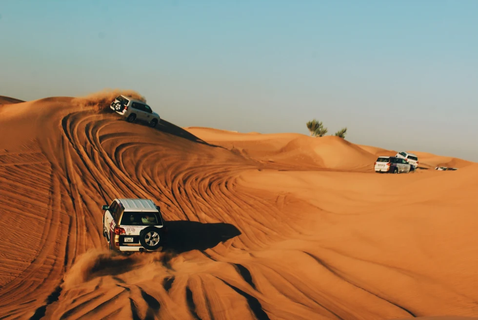 Cars driving on the golden desert in Dubai