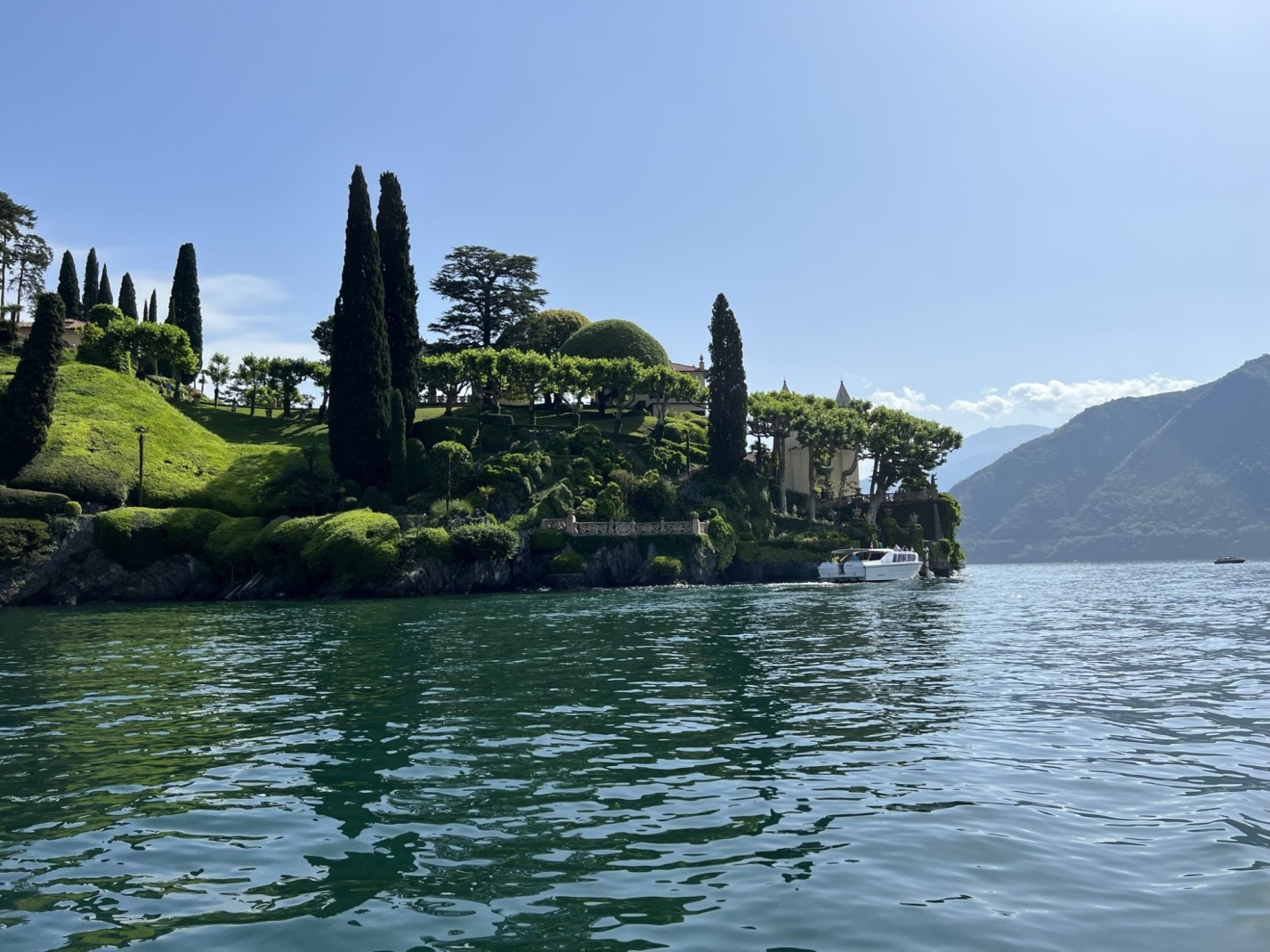 Villa del Balbianello in Lake Como from afar on a sunny day.