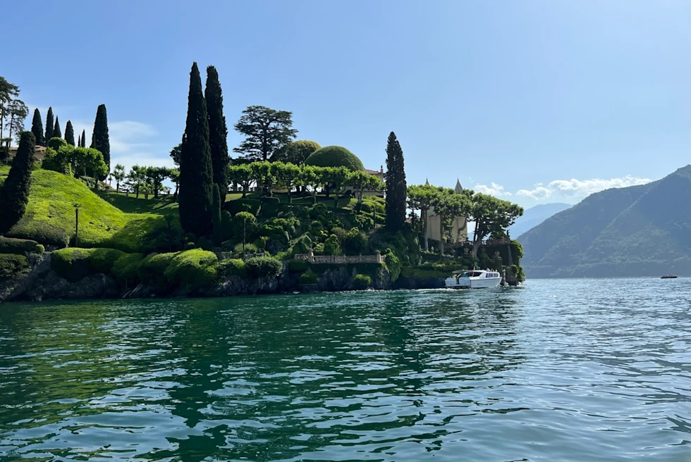 Villa del Balbianello in Lake Como from afar on a sunny day.