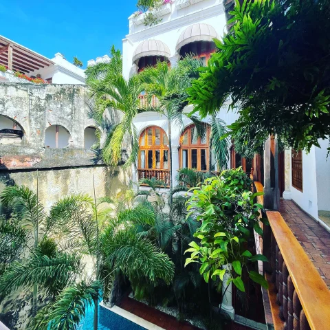 colorful courtyard with a pool and greenery