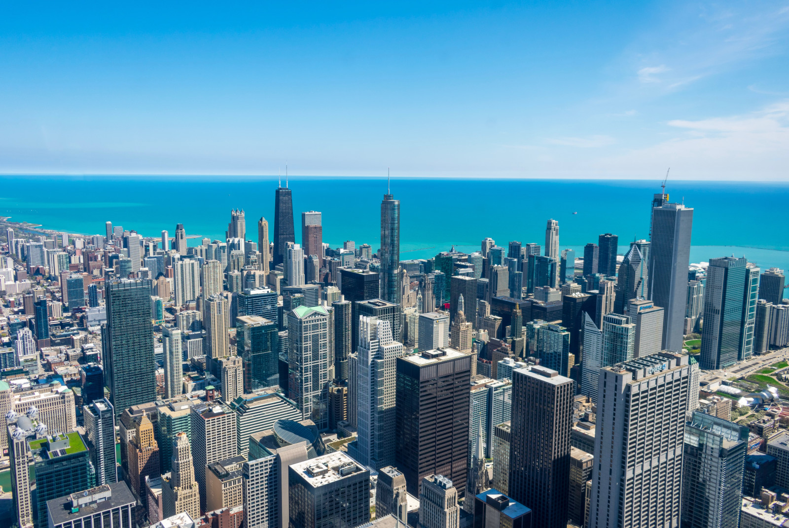 Aerial view of tall buildings next to body of water during daytime