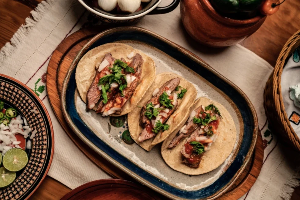 Delicious tacos being served on a tray at a restaurant 