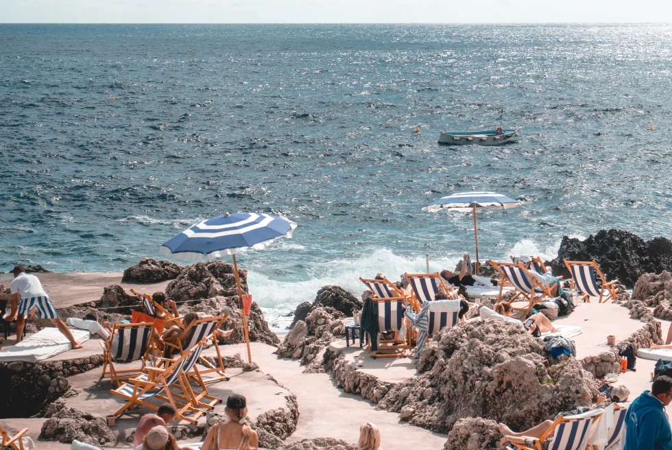 Beach club in Positano with striped chairs. 