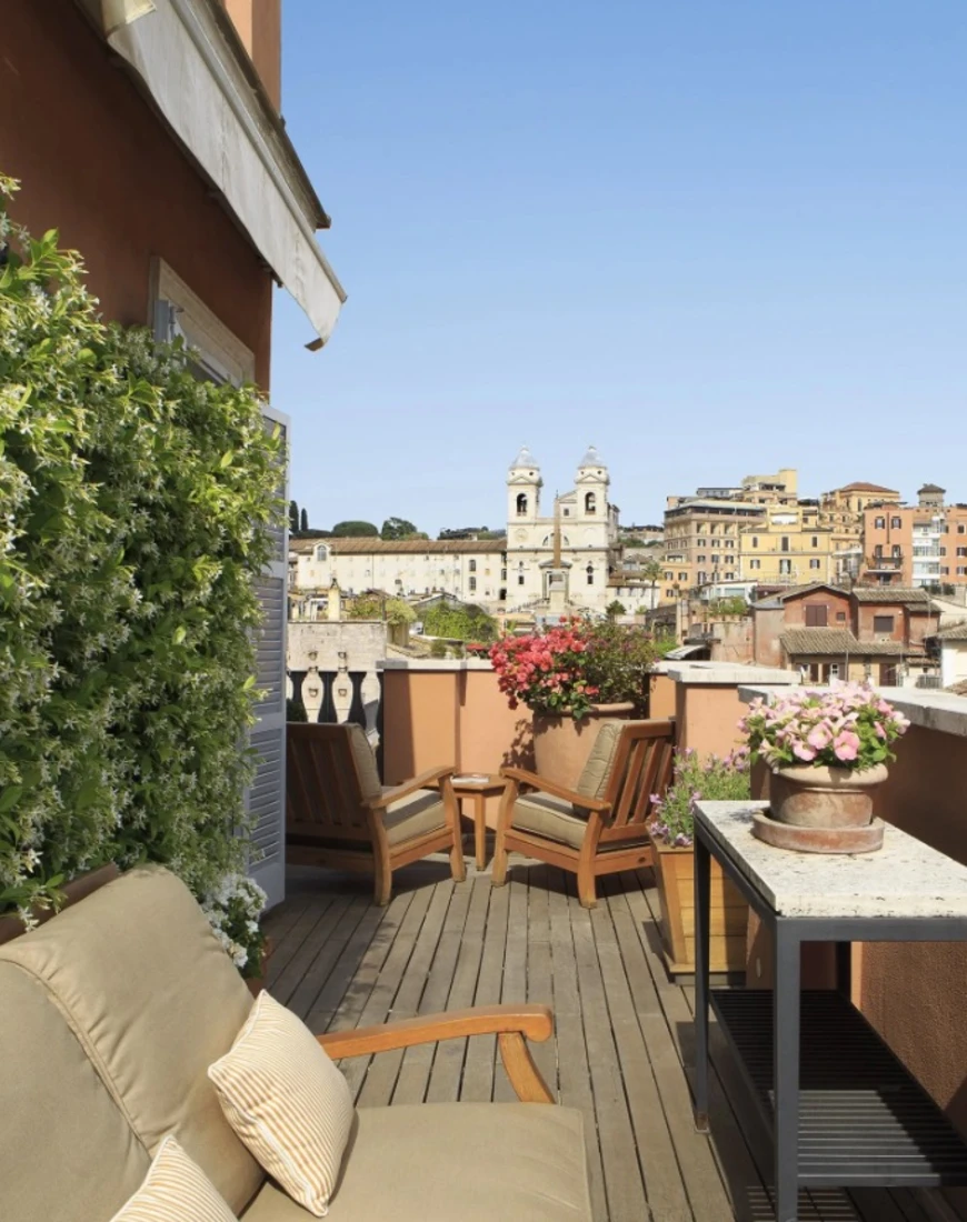 outdoor terrace overlooking rome with seating and flowers