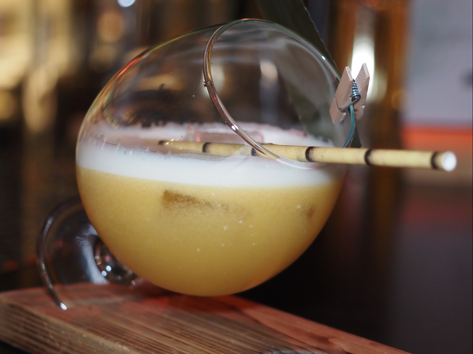 Yellow cocktail in a slanting glass.