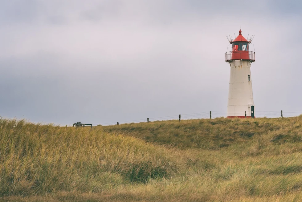 Sylt, Germany's northernmost island, exudes natural beauty and upscale tranquility, drawing visitors to its windswept dunes and chic coastal allure.