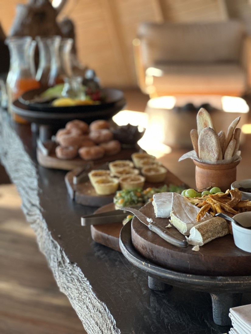 A buffet spread of tables with pastries and drinks