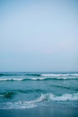 ocean waves rolling onto a beach