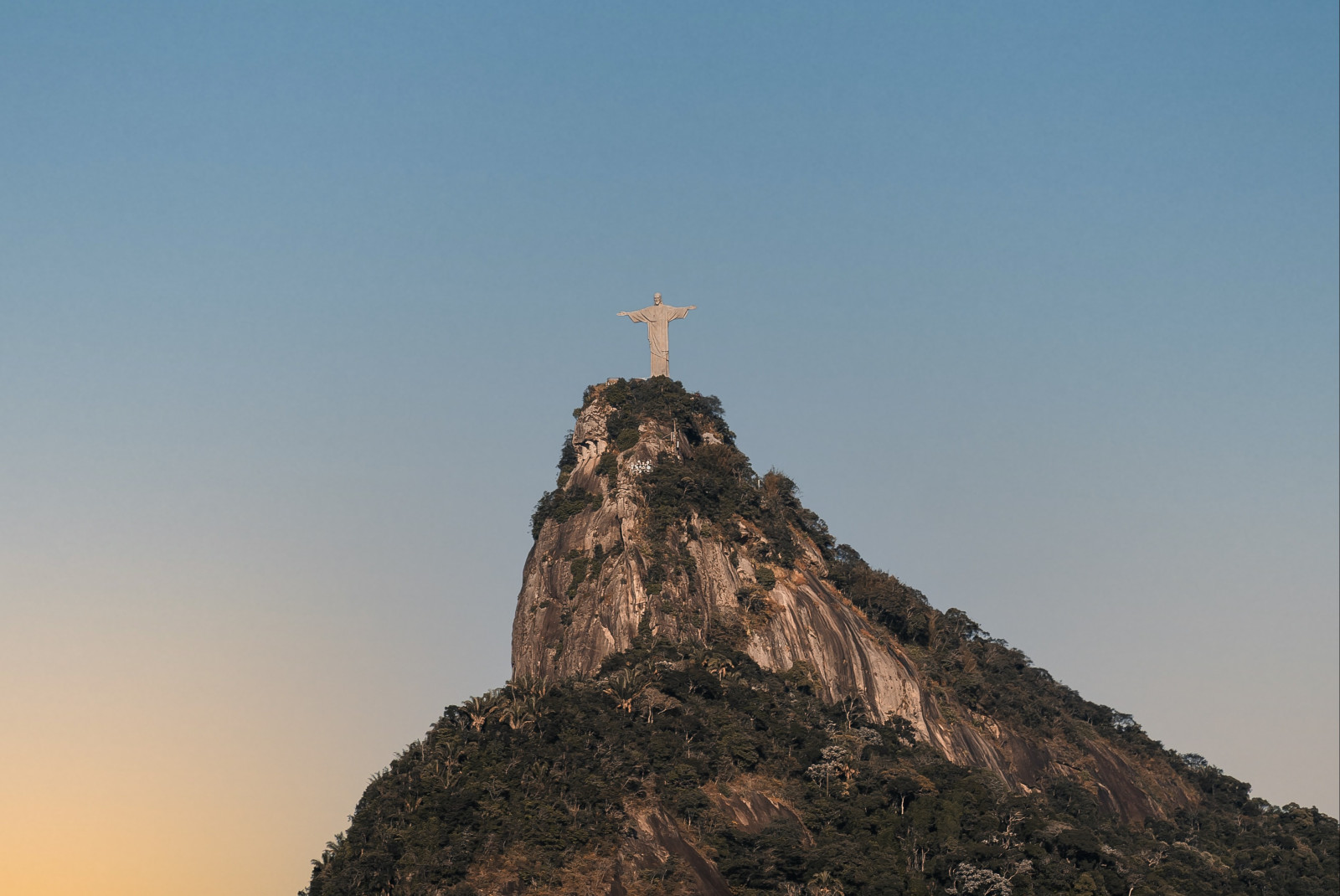 View of Christ the Redeemer statute on top of mountain in Brazil