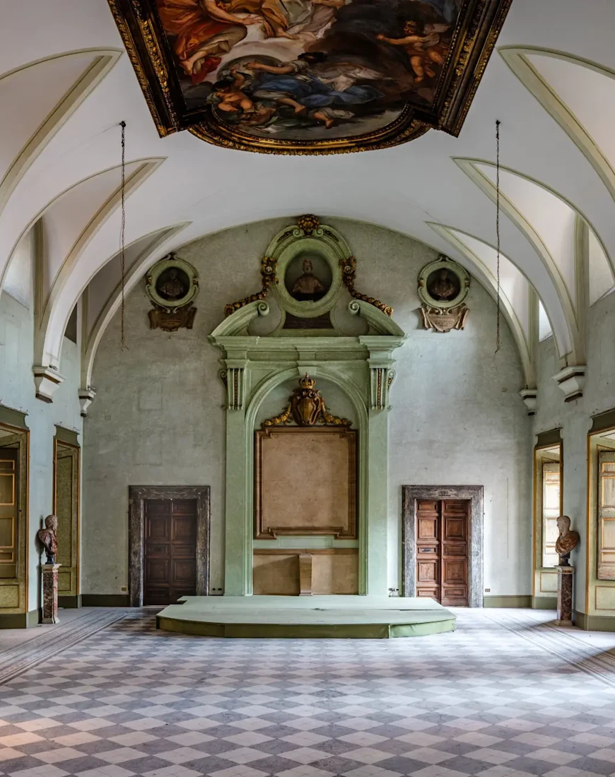 a grand entryway with tall vaulted ceilings and a mint-colored altar in high relief