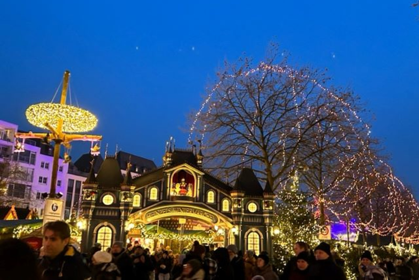 people standing near buildings with lights